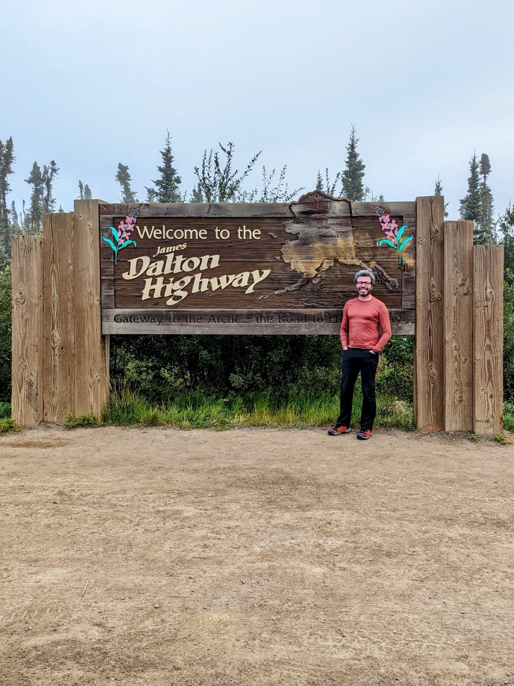 Yoni Ryabinski at the James Dalton Highway sign in Alaska